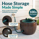 Bronze Embossed Panel Hose Pot shown storing a coiled garden hose, featuring a 100-foot hose capacity, 2-inch side opening for easy spigot connection, and three drainage holes to help reduce water buildup.