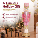 Timeless holiday gift infographic featuring a pink, white, and gold Christmas nutcracker displayed beside a decorated Christmas tree and wrapped gifts, with callouts for festive statement piece, classic holiday style, and made for gifting.