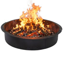 Black circular metal fire pit filled with burning logs, glowing embers, and large flames, shown on a white background.