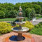 Large, white 4 tier grand courtyard fountain as a centerpiece on a brick patio