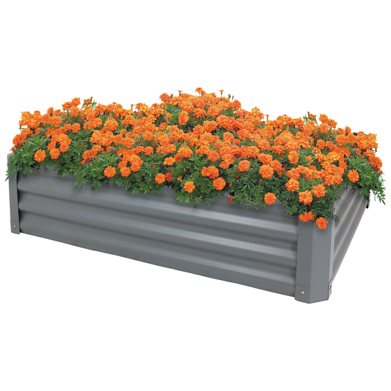 Gray, rectangular raised garden with orange flowers.