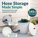 Ivory Glaze Decorative Metal Garden Hose Holder shown storing a coiled garden hose, featuring a 145-foot hose capacity, 2-inch side opening for easy spigot connection, and three drainage holes to help reduce water buildup.
