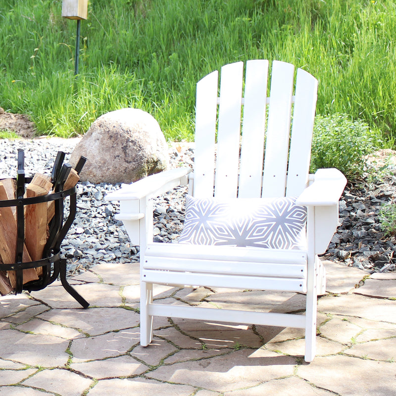 White Adirondack chair with gray geometric lumbar pillow.