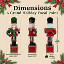 Holiday nutcracker decoration shown from front, side, and back views, featuring a red, green, black, and gold uniform with festive wreath accents. Measures 37 inches tall, 13.5 inches wide, and 9.25 inches deep, with a total weight of 14.2 pounds.