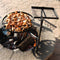 Dual swivel campfire cooking grate making chicken wings over a fire.
