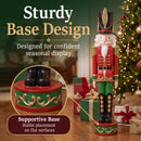 Red and green Kristoff Christmas Nutcracker shown beside a decorated Christmas tree and wrapped gifts, featuring a sturdy decorative base designed for stable placement on flat surfaces.