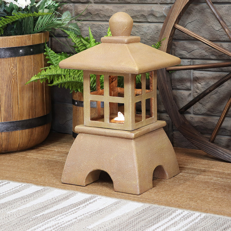 Traditional stone Japanese lantern style fountain on a wood deck with a gray outdoor rug with LED light that illuminates the flowing water 