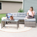 Woman enjoying a glass of wine while relaxing outdoors on the gray Longford low-back patio sectional sofa
