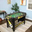 A foosball game table with realistic soccer field painting is set up in an entertainment room.

