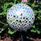 Mirrored diamond mosaic gazing ball globe shining in the backyard.
