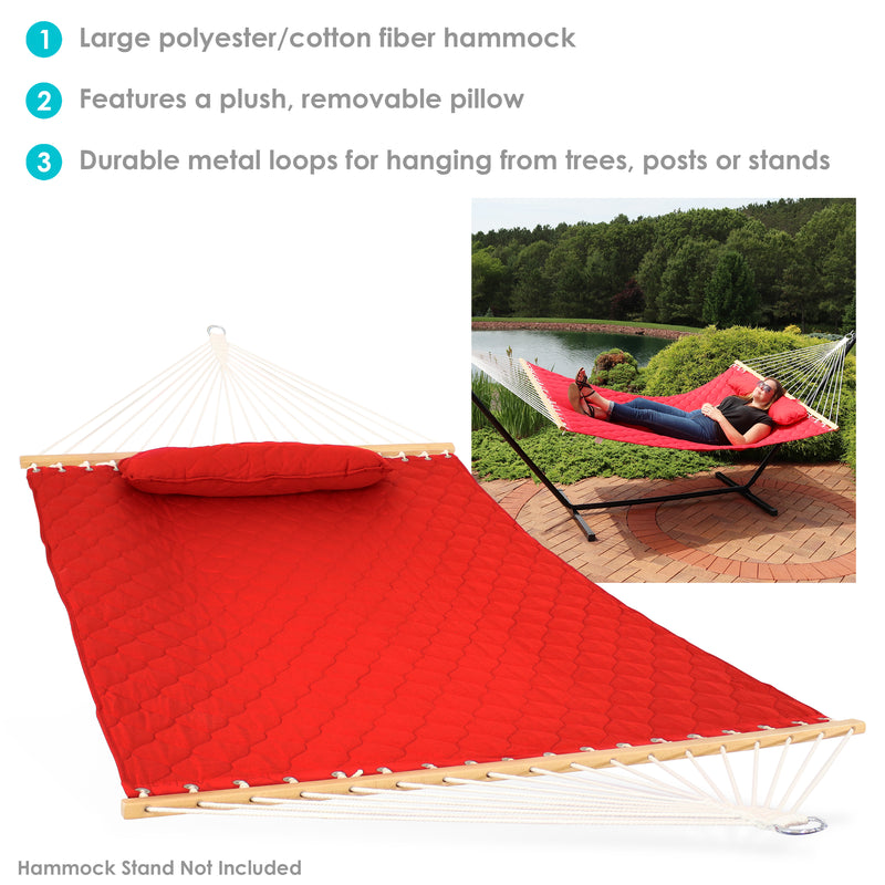 Red quilted hammock on a hammock stand sitting on a brick patio.