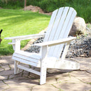 White Adirondack chair on a stone patio.