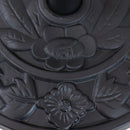 Back view of black half umbrella base with leaf detailing.