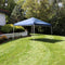 Blue 12'x12' pop up canopy fabric set up on a backyard lawn.