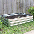 Silver galvanized steel raised garden bed filled with soil ready for planting