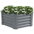 Gray, hexagon metal garden bed with white flowers.