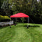 red 10'x10' pop up canopy with white frame and sandbags