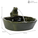 Green ceramic frog spitting water out it's mouth into the ceramic basin.