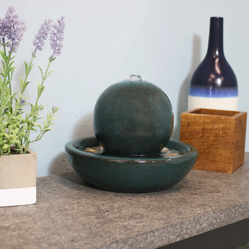 Ceramic tabletop fountain displayed on the living room.
