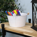 
Four white galvanized steel buckets with handle filled with various items placed bookshelf containing books and pictures.