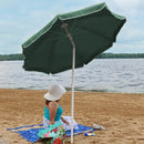 green beach umbrella with white trim and white pole.