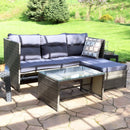 Purple, resin wicker patio sectional with gray cushions and resin wicker coffee table with glass top sitting in front.