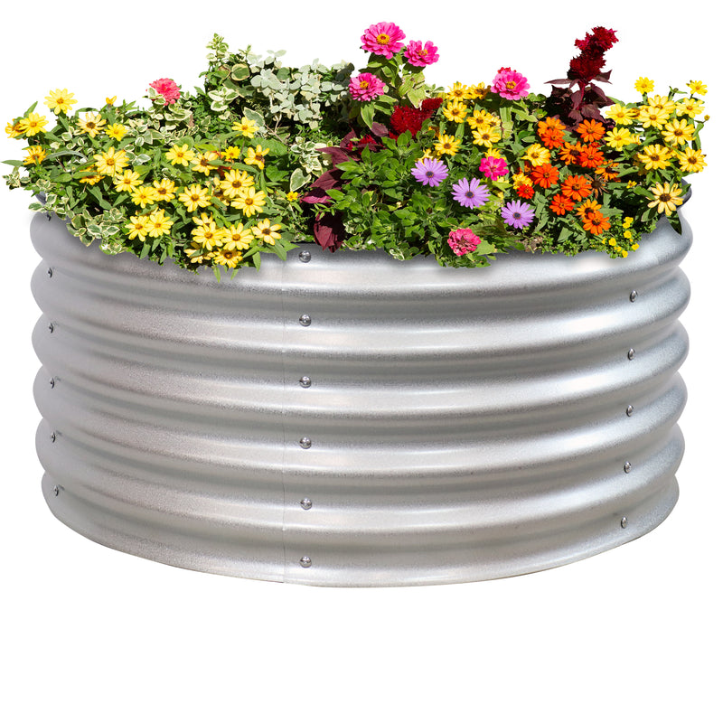 Silver, round, raised metal garden bed with colorful flowers.