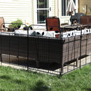 Black boarder fence with leaf details boarding a patio furniture set on a outdoor patio.