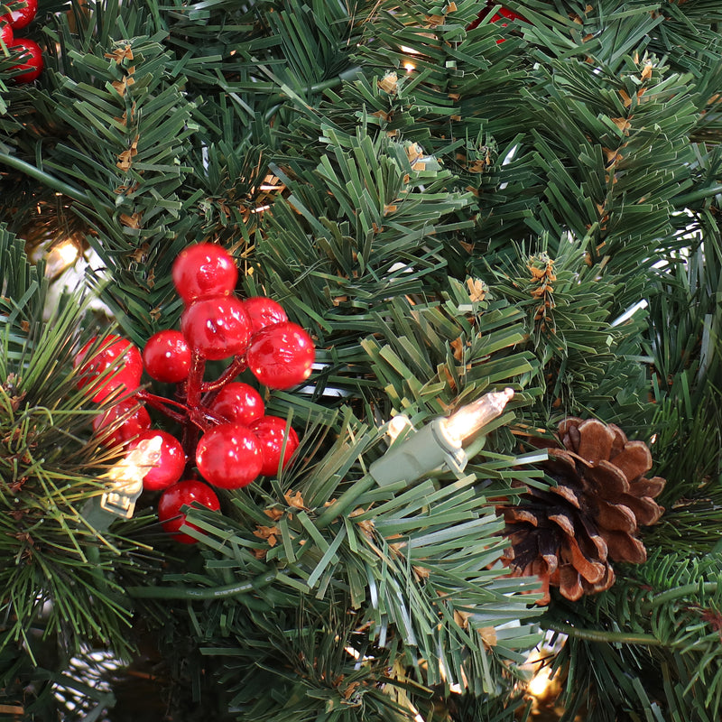 pre-lit artificial christmas tree with berries and pinecones