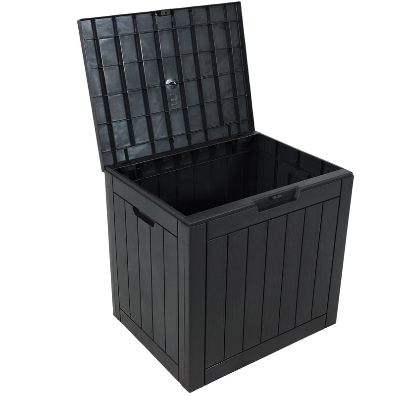 Closed black, small storage box in between two patio chairs.