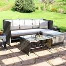 Gray, resin wicker patio sectional with gray cushions and resin wicker coffee table with glass top sitting in front.