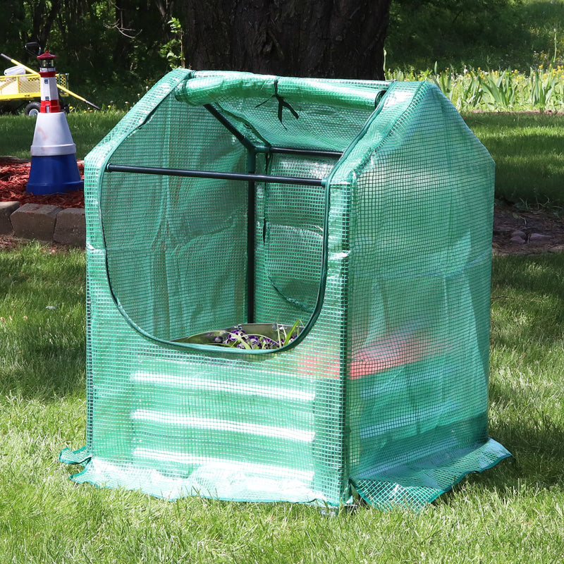 green plastic cover with zipper opening and black frame for mini greenhouse
