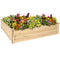 Wooden, raised garden bed with colorful flowers planted.