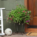Metal planter with flowers on front porch