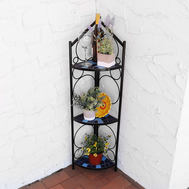 Mosaic tiled 3 tier corner plant stand holding flowers and decor on the front porch.
