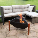 Triangle fire pit with copper legs sits in front of a gray soft with chaise lounge.