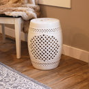 White lattice ceramic garden stool sitting on hardwood floor  

