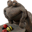 Backside of the brown turtle statue with green leaf table holding red ladybugs and yellow bees.