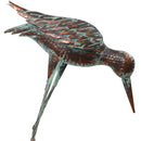 Light blue and copper-colored feet of outdoor metal crane statue.