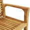 Wooden teak arm chair sitting on a gray outdoor rug.