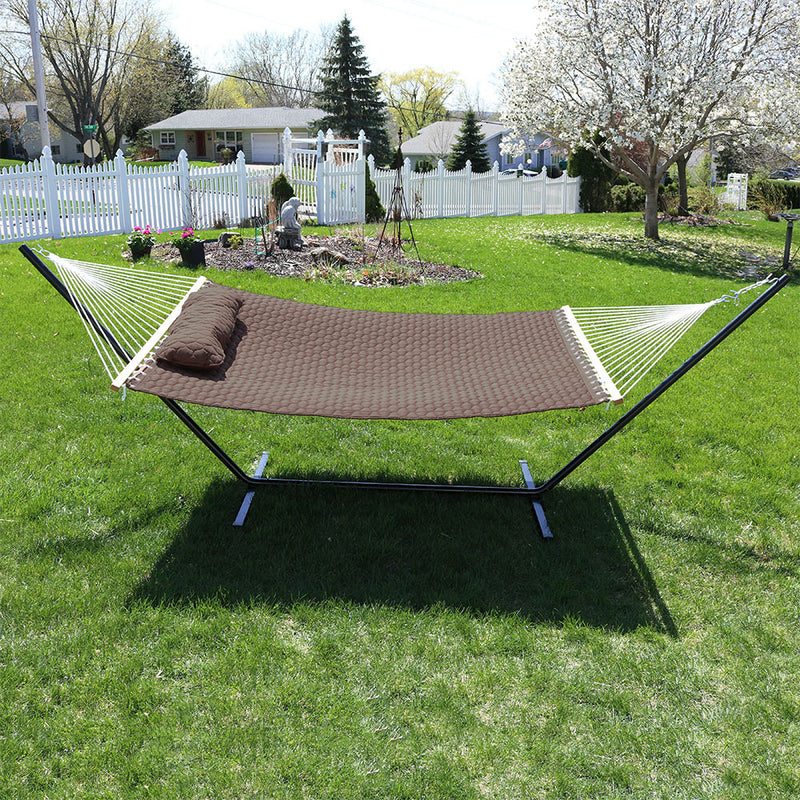 brown quilted hammock with matching pillow and black metal stand
