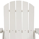 Man sitting in a white Adirondack chair with his back resting on a pillow.