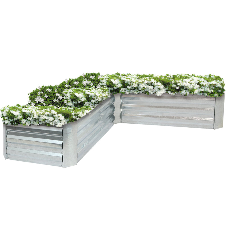 L-shaped garden bed filled with white flowers.