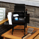 Mini bbq grill statue holding napkins and other grilling seasonings.