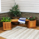 Planter box bench with plants on each side and blue striped blanket on the bench section.