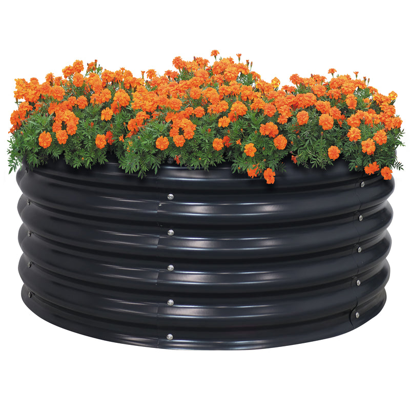 Black, round, raised metal garden bed with orange flowers.