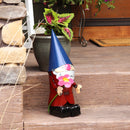 Small metal gnome with blue hat on front steps