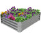 Rectangular, steel garden bed with color flowers planted inside.