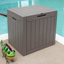 Faux wood storage deck box with lockable lid sitting pool side.