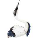 Profile of white crane with black beak, blue chest feathers, and orange legs and feet.
